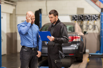Fototapeta na wymiar auto mechanic and customer at car shop
