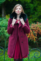 Beautiful young blonde woman wearing fur autumn coat