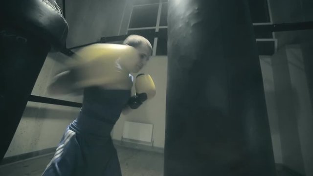 Boxer punching bag. Slow motion.