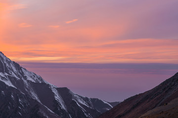 Naklejka na ściany i meble orange sunset over the mountain peaks