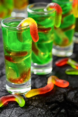 green Halloween jello shots with gummy worms