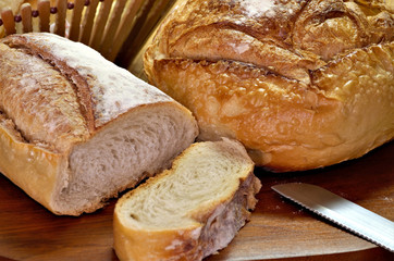 Delicious breads on wooden table seen from above.