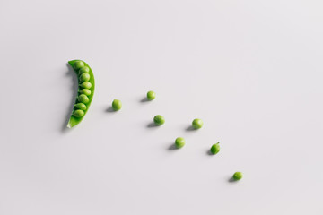 Fresh open pea pod and seeds on white background. Copy space.