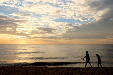 Fototapeta premium Silhouette of people on the cha-am beach, thailand