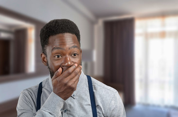 Black man covering his mouth