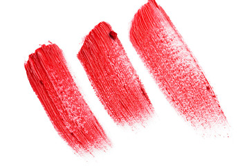 Smudged lipsticks isolated on white background