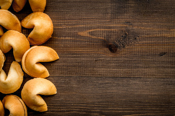 Prediction in fortune cookie on wooden background flat lay mockup