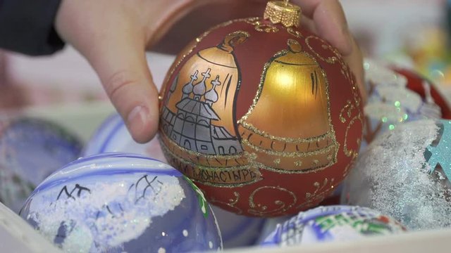 Close-up of New Year theme man's hand taking glass bowl with patten and slowly rotate it