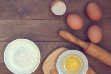Eggs, flour, rolling pin, shape, corolla, baking ingredients with a copy of a stretch in a vintage style