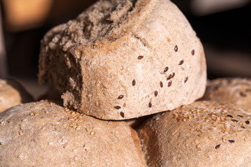 Organic home made bread with flax seeds and rural background
