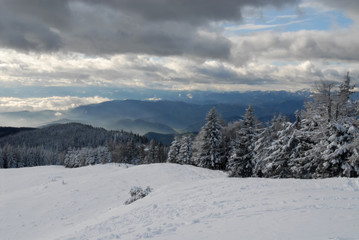 Fototapeta na wymiar View of the winterly Austrian and Slovenian alps from mountain Schöckl, Graz, Austria