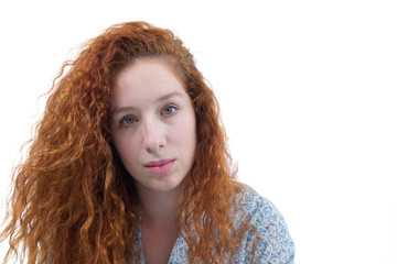 Woman with beautiful hair. A redheaded teenager has curly hair and wears a floral print outfit..