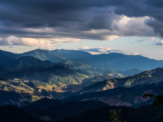 The great moment of nature where the sunlight is shine toward the mountain valley while trekking to the top of Doi Phu Wae at Nan, Thailand. The light is so bright comparing to the dark cloudy sky