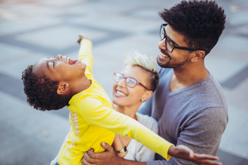 Happy young mixed race couple spending time with their daughter