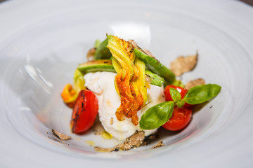 Mozzarella cheese tomato and basil on a plate