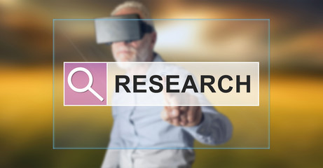 Fototapeta na wymiar Man wearing a reality virtual headset touching a research concept on a touch screen