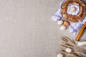 Homemade Ukrainian bread Kalach, eggs, flour, rolling pin and ears of wheat