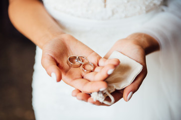 Woman hands holding wedding rings