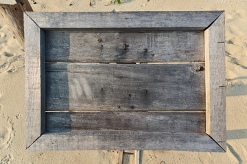 empty old wooden Whiteboard (menu board) on a tropical beach