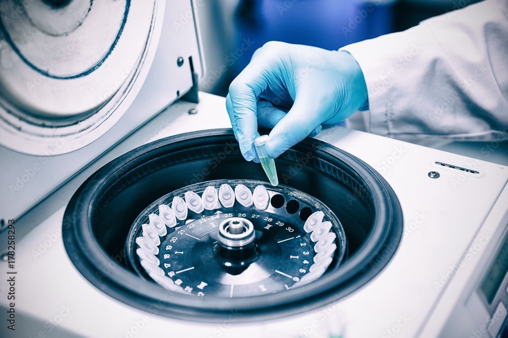 Poster close up of a chemist using a centrifuge