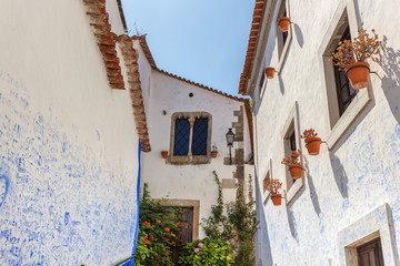 Historic Portuguese village of Obidos and narrow streets with cobblestone.