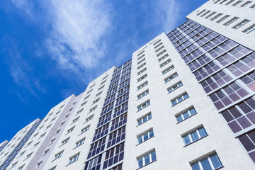 Fototapeta premium New tall apartment building against the sky