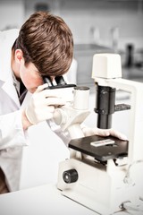 Scientist looking in a microscope