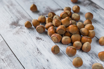 hazelnut on white wooden background