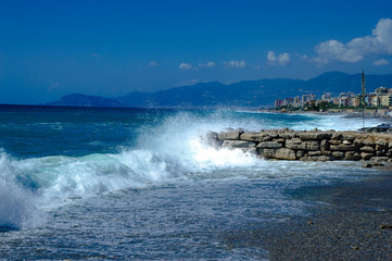 Waves break about a stone pier