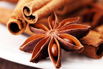 Fragrant star anise and cinnamon on wooden table.