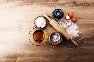 Fototapeta na wymiar Baking ingredients for homemade pastry on wooden background. Bake sweet cookies concept
