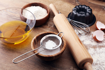 Baking ingredients for homemade pastry on wooden background. Bake sweet cookies concept