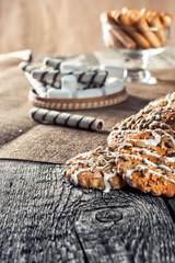 Still life recipe homemade honey ginger oatmeal cookie, pirouette rolled wafer and grain stick on wooden table kitchen