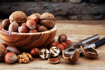 Large diversity of healthy nuts in wooden bowl.
