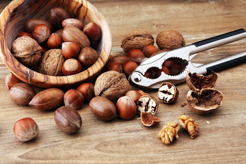 Large diversity of healthy nuts in wooden bowl.