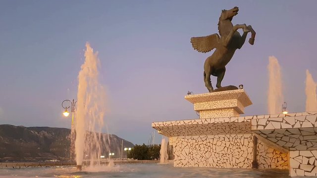 Central square in Corinth with a fountain and the statue of Pegasus.