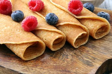 Delicious Tasty Homemade crepes or pancakes with raspberries and blueberries