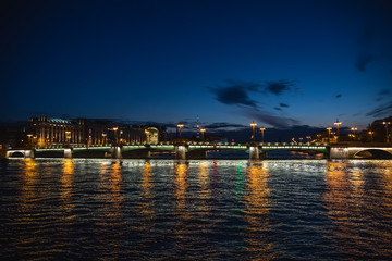 Fototapeta premium Bridge in Saint-Petersburg with lights illumination in summer white night, Neva river