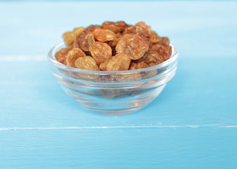 raisins in a cup on a blue background
