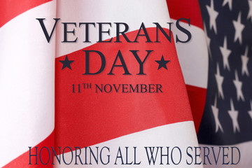 Fototapeta na wymiar Veterans day background. Text veterans day 11 th november. United States of America flag with the inscription honoring all who served.