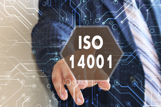 The Businessman Is Choosing ISO 14001 On The Touch Screen With A Futuristic Background. Requirements For Environmental Management System And Audit.