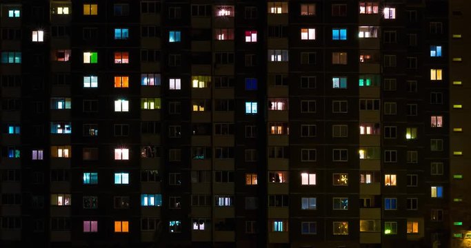 Light in the windows of a multistory building. Time lapse