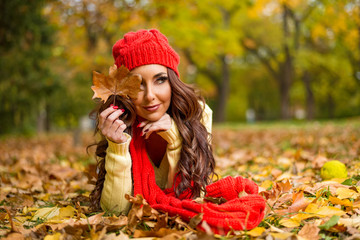 Young beautiful woman in autumn park