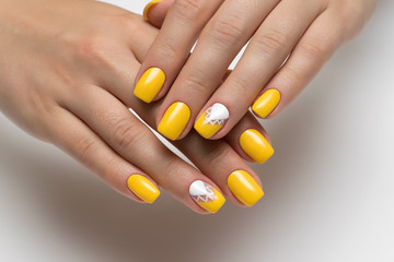 yellow nails with white triangles on square short nails