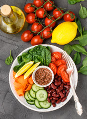 Vegetarian buddha bowl. Raw vegetables - tomatoes, cucumbers, beans, spinach, carrots, lemon and flax seed in a bowl. healthy, detox food concept. Selective focus