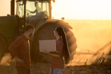 Farmers with laptop in field at sunset © Budimir Jevtic