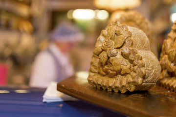 Award winning pork pie with decorative pastry on a market stall in the UK