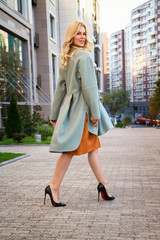 Fashionable beautiful girl in a mint coat - 178268892