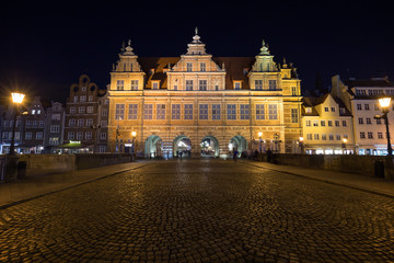 View of a cobblestone street and historic Green Gate, the formal residence of Poland's monarchs, at...
