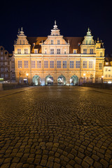 View of a cobblestone street and historic Green Gate, the formal residence of Poland's monarchs, at...